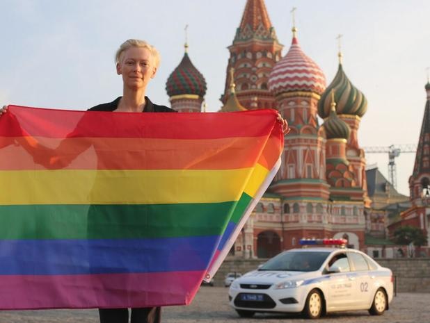 tilda swinton waves gay pride rainbow flag in
